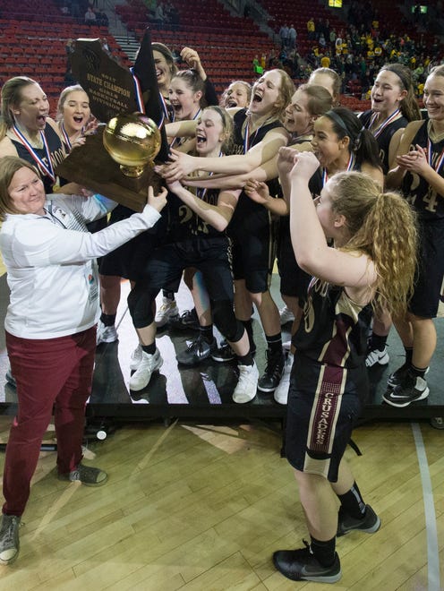 Madison Edgewood receives their championship trophy after their WIAA girls basketball Division 3 state championship game.