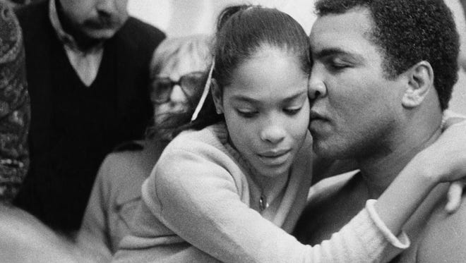 Ali embraces his daughter Rasheda Ali after a boxing match in 1981.