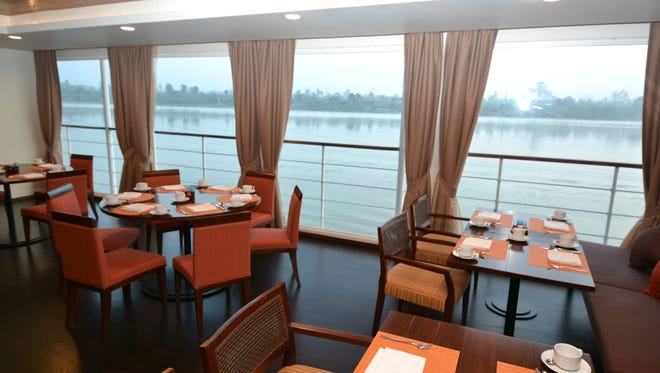 Like other public spaces on the Avalon Myanmar, the dining room has wall-to-wall windows offering spectacular views of the passing river.