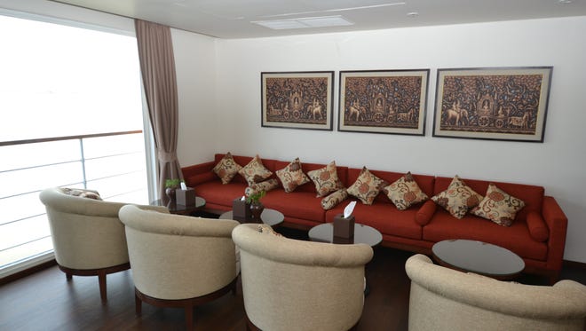 Seating in the Avalon Myanmar's indoor lounge looks out over panoramic, wall-to-wall windows.