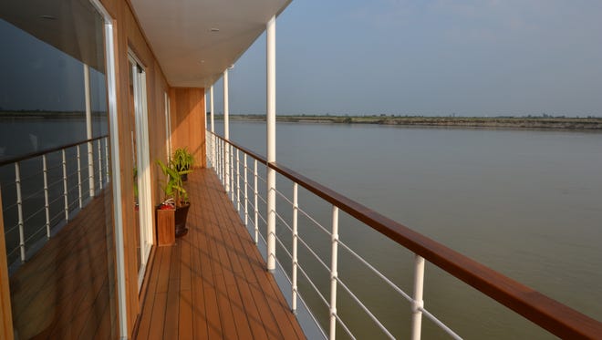 An outoor walkway lines one side of the Avalon Myanmar's second deck.