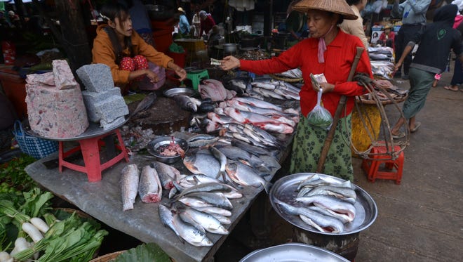Stops along the Irrawaddy River include small villages with colorful local markets.