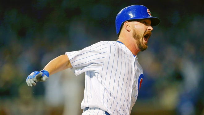 Game 2 at Chicago: Cubs relief pitcher Travis Wood celebrates after hitting a home run during the fourth inning.