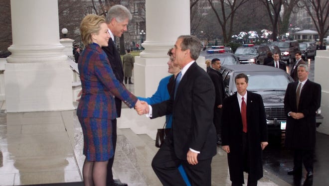 The Clintons greet the Bushes at the front door of the White House before heading to the Capitol for the inauguration on Jan. 20, 2001.