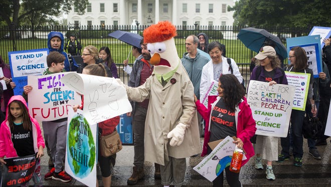 Members of the Union for Concerned Scientists pose for photographs with Muppet character Beaker in front of The White House before heading to the National Mall for the March for Science rally in Washington, D.C.