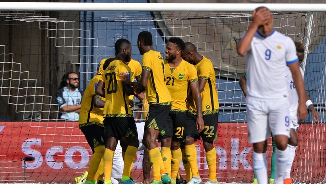 Jamaica celebrates following a goal from forward Darren Mattocks as Curacao forward Gino Van Kessel (9) reacts. Jamaica won the game, 2-0, which was played at Qualcomm Stadium in San Diego.