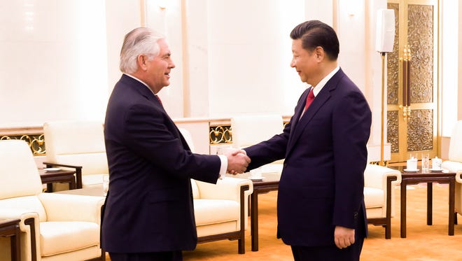 Secretary of State Rex Tillerson, left, shakes hands with Chinese President Xi Jinping, at the Great Hall of the People in Beijing on March 19, 2017.