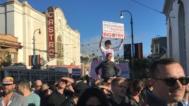 Protesters listen to speakers at a demonstration against a proposed ban of transgendered people in the military in the Castro District on July 26, 2017, in San Francisco. Demonstrators flocked to a plaza named for San Francisco gay-rights icon Harvey Milk to protest President Donald Trump's abrupt ban on transgender troops in the military.