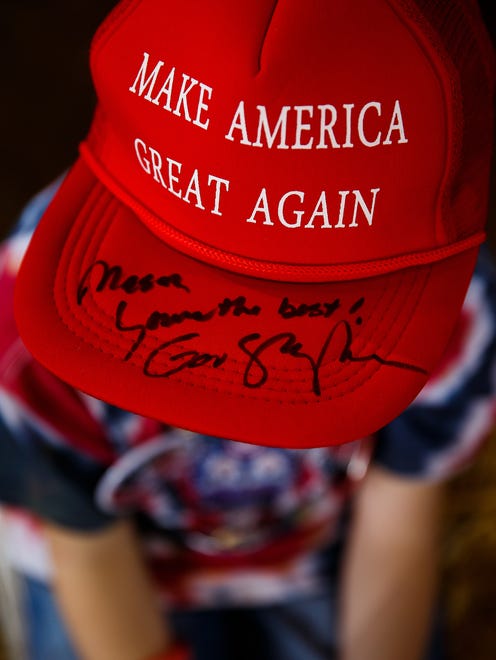 Mason Hialaburton, 7 form Omaha displays his "Make America Great Again" hat signed by GOP VP nominee Mike Pence before Sen. Joni Ernst's Roast and Ride at the Iowa State Fairgrounds on Saturday, August 27, 2016 in Des Moines.
