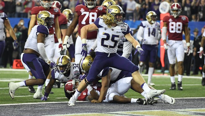 Washington linebacker Ben Burr-Kirven celebrates after a stop against Alabama during their College Football Playoff semifinal at the Peach Bowl.