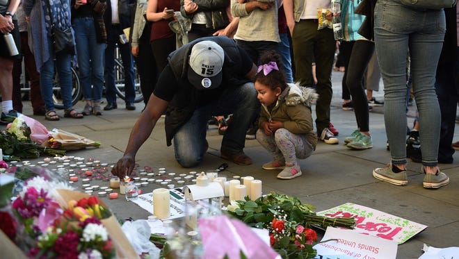 Mourners in Albert Square in Manchester on May 23, 2017, after a vigil for those killed and injured in the May 22 terror attack at the Ariana Grande concert at the Manchester Arena.