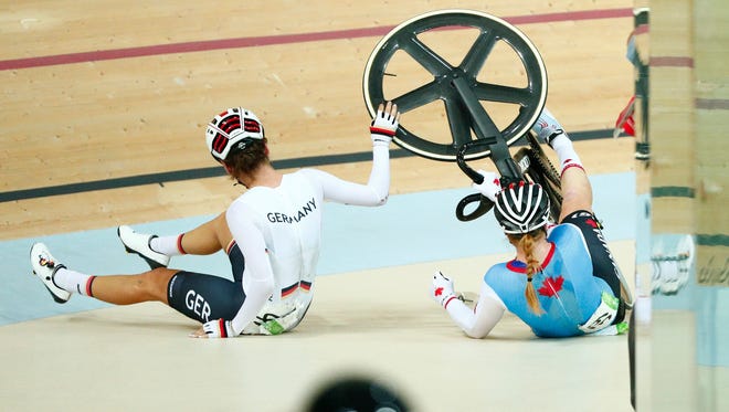 Anna Knauer of Germany, right, and Allison Beveridge of Canada crash during the women's omnium scratch race 1/6 in the Rio 2016 Summer Olympic Games at Rio Olympic Velodrome.