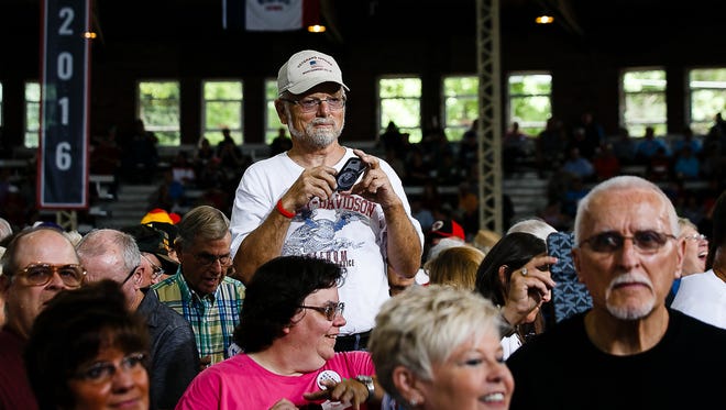 People take photos as Sen. Joni Ernst arrives and talks to the press at her Roast and Ride at the Iowa State Fairgrounds on Saturday, August 27, 2016 in Des Moines.