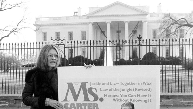 Gloria Steinem, publisher of the magazine Ms., holds a mock-up of that publication's January cover while standing in front of the White House, on Dec. 16, 1977. The issue rated President Carter's first year in office from a feminist perspective.