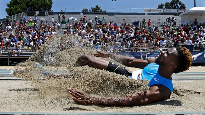 Jarrion Lawson lands a in the sand during the men's long jump. He won with a leap of 8.49 meters.