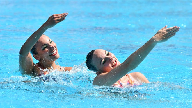 Nikita Pablo and Rose Stackpole of Australia compete during the synchronized swimming women's preliminary round duet technical routine in the Rio 2016 Summer Olympic Games at Maria Lenk Aquatics Centre.