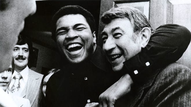 Ali embraces ABC sportscaster Howard Cosell in 1975.