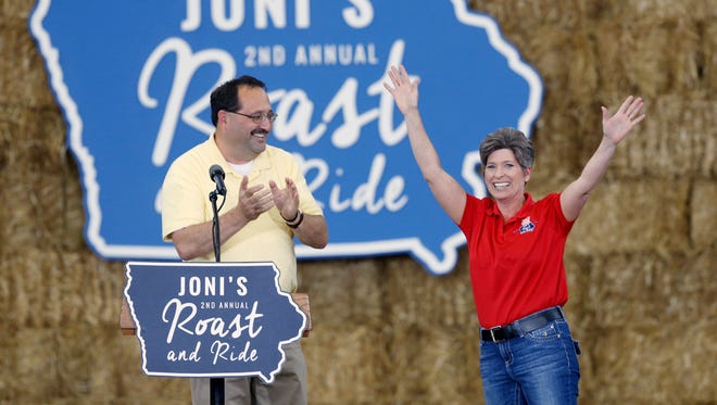Sen. Joni Ernst (right) comes on stage after being introduced by Republican Party of Iowa chairman Jeff Kaufmann Saturday, Aug. 27, 2016, during the second annual Roast and Ride at the Iowa State Fairgrounds in Des Moines.