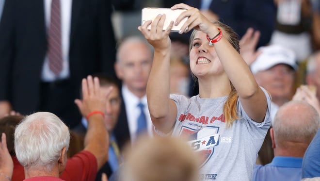 Libby Husske of Waukee takes a selfie as Republican presidential candidate Donald Trump walks off stage Saturday, Aug. 27, 2016, during the second annual Roast and Ride at the Iowa State Fairgrounds in Des Moines.