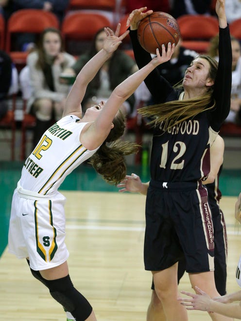 Greendale Martin Luther's Emma Kallas has the ball stripped by Madison Edgewood's Estella Moschkau (right) during their WIAA girls basketball Division 3 state championship game.