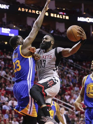 Houston Rockets guard James Harden (13) drives to the basket against Golden State Warriors forward Draymond Green (23) in the first quarter at Toyota Center.