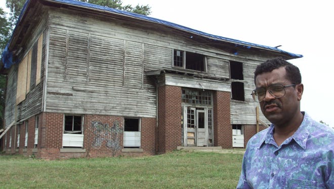 ADVANCE FOR JUNE 24-26--Stanley Madison whose ancestors helped found Lyles Station Ind.poses June 2 2000  outside the old Lyles Consolidated School where the federal government is expected to pay $1.25 million to convert the building into a place where today's students can learn about the area's history. The Gibson County town in the southwestern courner of Indiana was founded by freed slaves more than 150 years ago. (AP Photo/Michael Conroy)