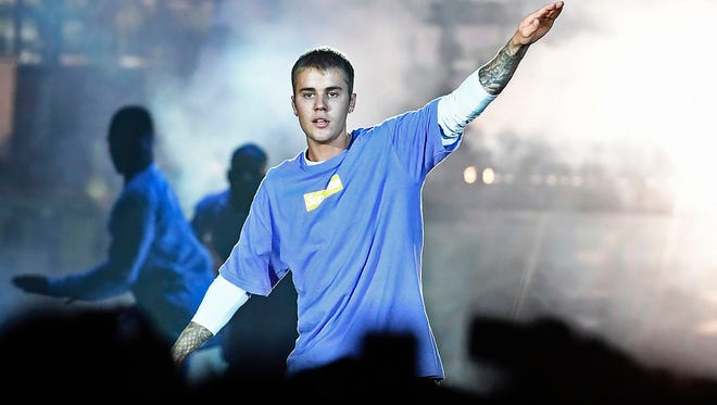 This file photo taken on Sept. 20, 2016, shows Canadian singer Justin Bieber performing on stage at the AccorHotels Arena in Paris. He has canceled the remaining shows of his highly successful Purpose World Tour.