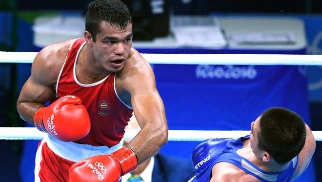Bektemir Melikuziev (UZB, blue) fights Krishan Vikas (IND, red) in a men’s middleweight quarterfinal bout at Riocentro - Pavilion 6 during the Rio 2016 Summer Olympic Games.