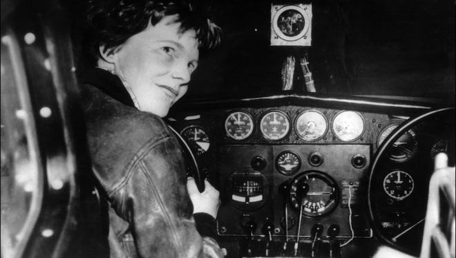 An undated 1930's file photo shows US aviator Amelia Earhart at the controls of an aircraft in Essonne, France.