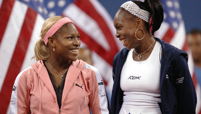 Serena Williams, left, celebrates winning the 2002 U.S. Open against her sister Venus.