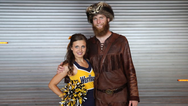 West Virginia Mountaineers mascot and cheerleader pose for a photo during the Big 12 Media Days at Omni Dallas Hotel.