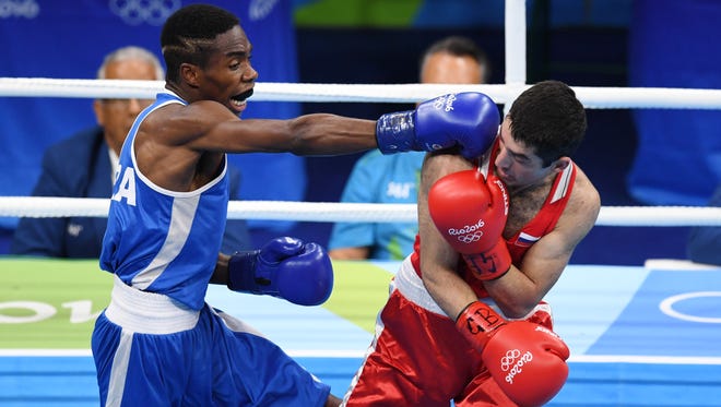 Elie Konki (FRA, blue) fights Misha Aloian (RUS, red) in a men’s flyweight preliminary bout at Riocentro - Pavilion 6 during the Rio 2016 Summer Olympic Games.