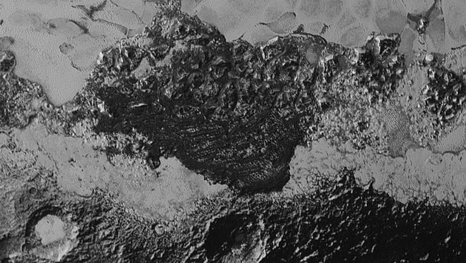This 220-mile (350-kilometer) wide view of Pluto from NASA’s New Horizons spacecraft illustrates the incredible diversity of surface reflectivities and geological landforms on the dwarf planet. The image includes dark, ancient heavily cratered terrain; bright, smooth geologically young terrain; assembled masses of mountains; and an enigmatic field of dark, aligned ridges that resemble dunes; its origin is under debate. The smallest visible features are 0.5 miles (0.8 kilometers) in size. This image was taken as New Horizons flew past Pluto on July 14, 2015, from a distance of 50,000 miles (80,000 kilometers).