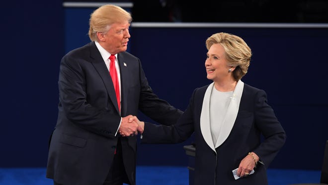 Democratic presidential candidate Hillary Clinton and Republican presidential candidate Donald Trump shake hands after the second presidential debate at Washington University in St. Louis.