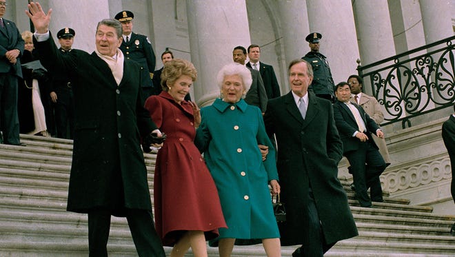The Reagans accompany the new president and first lady down the Capitol steps after the inaugural ceremony on Jan. 20, 1989.