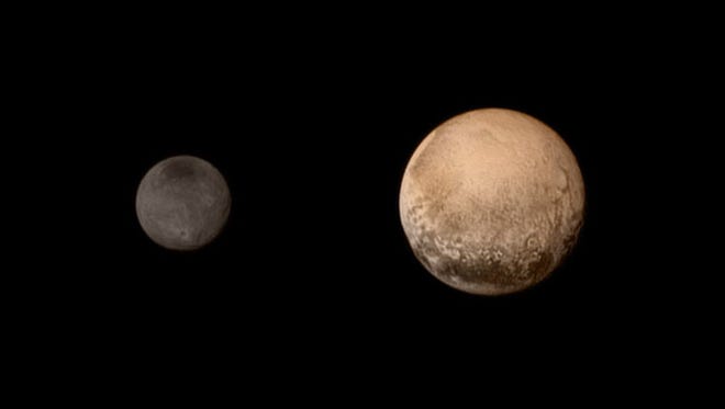 Pluto (R) and moon Charon, July 11, 2015