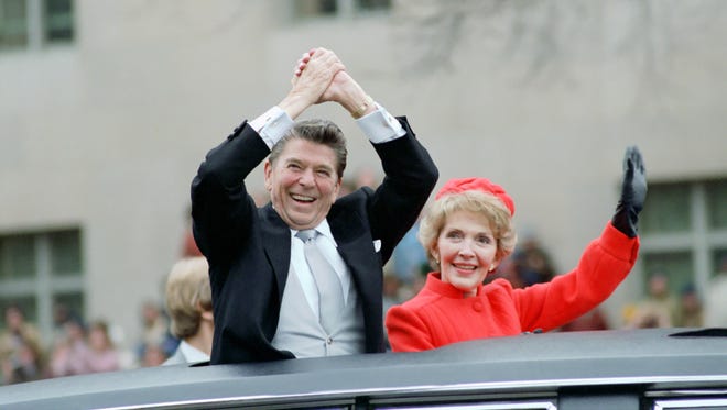 The Reagans wave from their limousine during the inaugural parade on Jan. 20, 1981.