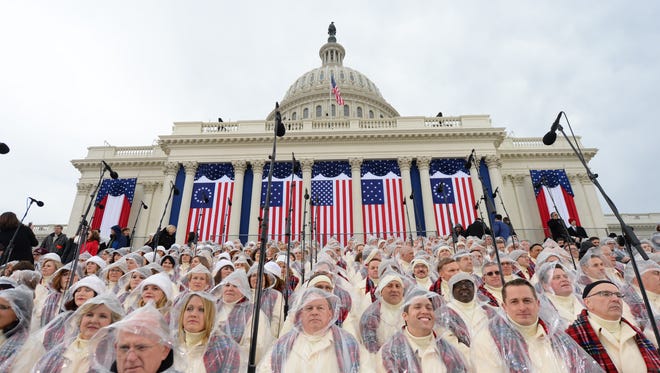 Choir members wear rain coverings ahead of the 2017 Presidential Inauguration at the U.S. Capitol.