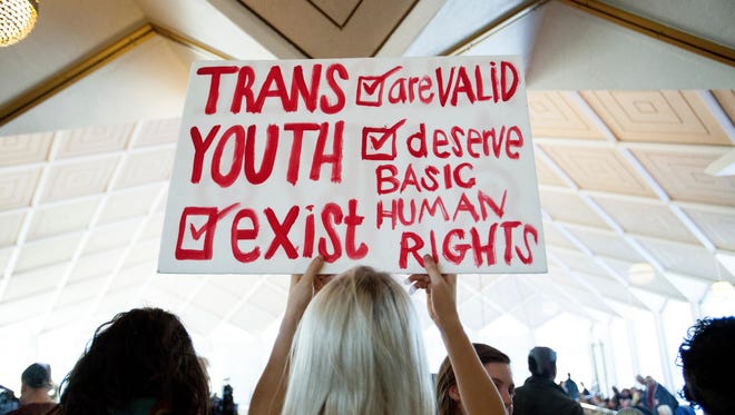 Hunter Schafer of Raleigh, N.C., holds a sign in favor of repealing North Carolina HB2 law during a special session of the North Carolina General Assembly on  Dec. 21, 2016.