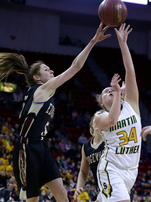 Greendale Martin Luther's Grace Amling (right) is defended by Madison Edgewood's Katie Meriggioli during their WIAA girls basketball Division 3 state championship game.