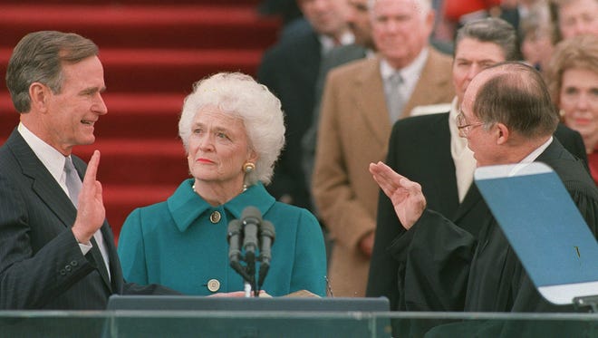 President George H.W. Bush is sworn into office as the 41st president of the United States by Chief Justice William Rehnquist outside the West Front of the Capitol on Jan. 20, 1989.