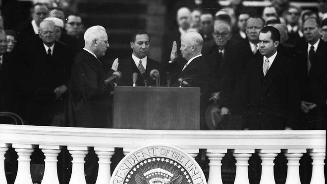 Eisenhower takes the oath of office for his second term at the Capitol on Jan. 21, 1957, with Chief Justice Earl Warren administering the oath.