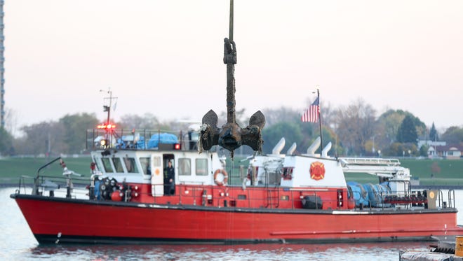 A 6,000 pound anchor belonging to the Greater Detroit luxury steamship is lifted from the Detroit river using a crane provided by the Great Lakes Maritime Institute, as the Curtis Randolph fireboat  stands watch on Tuesday, Nov. 15, 2016.