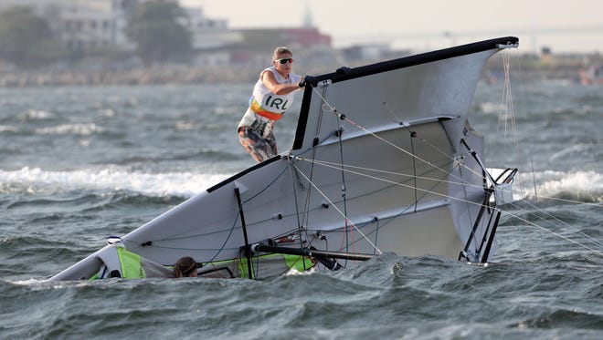 Andrea Brewster (IRL) and Saskia Tidey (IRL) capsize during the women's sailing 49er FX open series in the Rio 2016 Summer Olympic Games at Marina da Gloria.