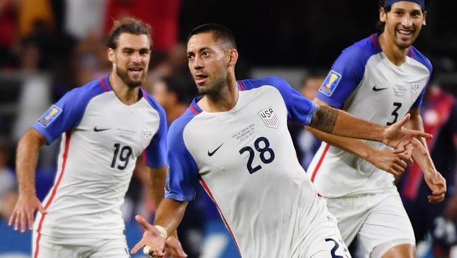 Clint Dempsey (28) celebrates with teammates Graham Zusi (left) and Omar Gonzalez after scoring a goal during a CONCACAF Gold Cup semifinal against Costa Rica in Arlington, Texas. The U.S. won, 2-0, and Dempsey tied a record for most national team goals (57) held by Landon Donovan.