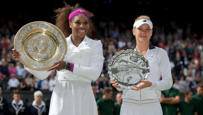 Serena Williams, left, and Agnieszka Radwanska hold up their trophies after their match in the women's singles finals of the 2012 Wimbledon Championships. Williams won 6-1, 5-7, 6-2.