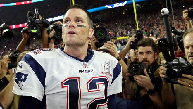 New England Patriots quarterback Tom Brady (12) celebrates after beating the Atlanta Falcons during Super Bowl LI at NRG Stadium.