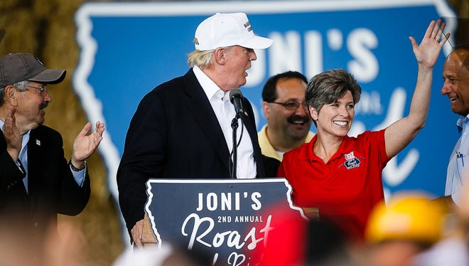 Republican Presidential candidate Donald Trump is accompanied by Sen. Joni Ernst during her Roast and Ride event at the Iowa State Fairgrounds on Saturday, August 27, 2016 in Des Moines.