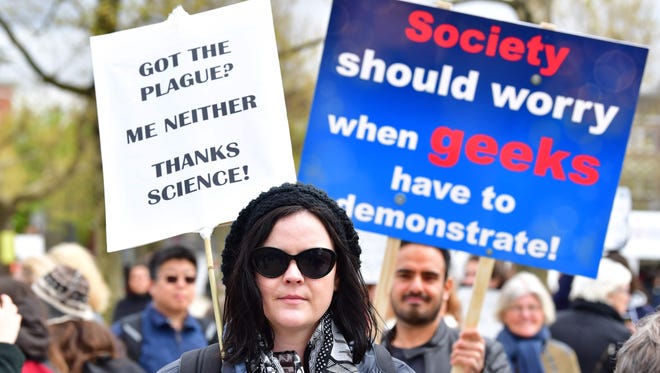 Demonstrators carry placards as they participate in the March for Sciences in Amsterdam.