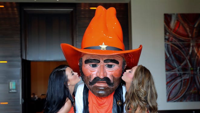 Oklahoma State Cowboys cheerleaders and mascot pose for a photo during the Big 12 Media Days at Omni Dallas Hotel.